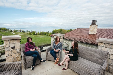 Happy group of friends enjoys a tasting on Mari's mezzanine level