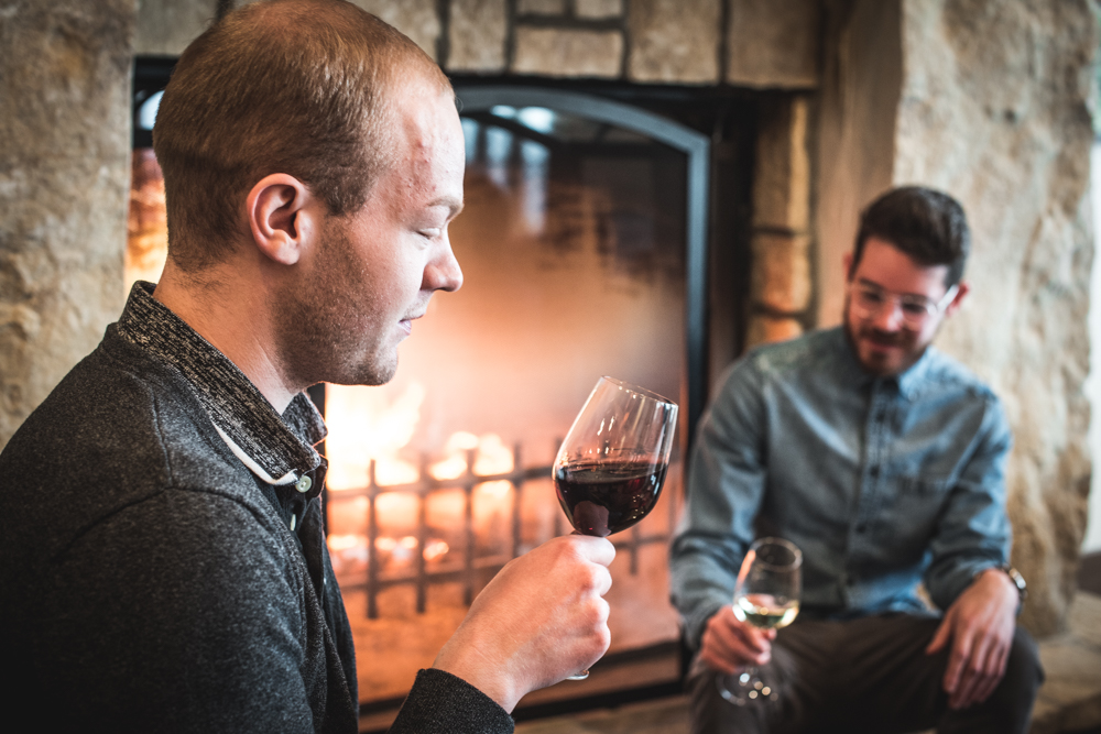 Guests enjoying wine by the fire