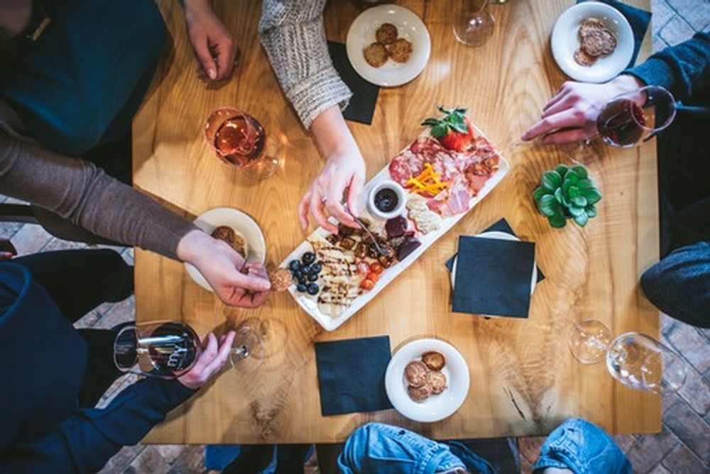 Charcuterie Board with guests eating