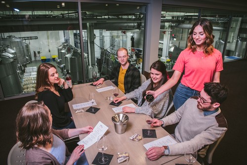 Happy group of friends enjoys a tasting on Mari's mezzanine level