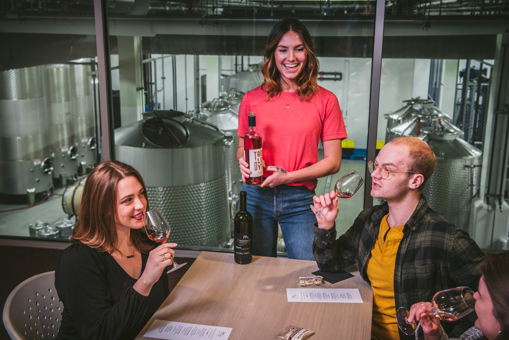 Happy group of friends enjoys wine on the terrace